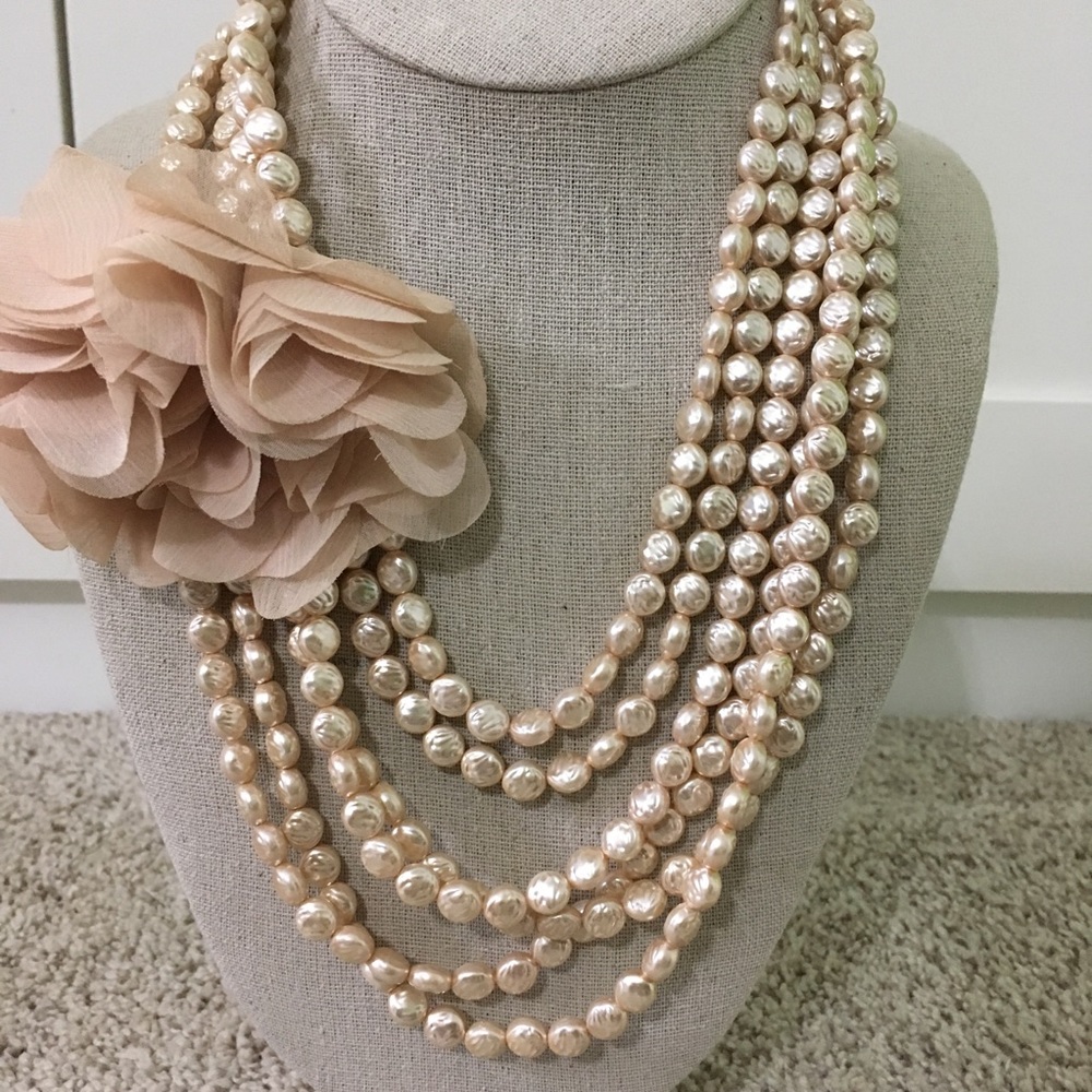 Faux pearl necklace with flower broach.